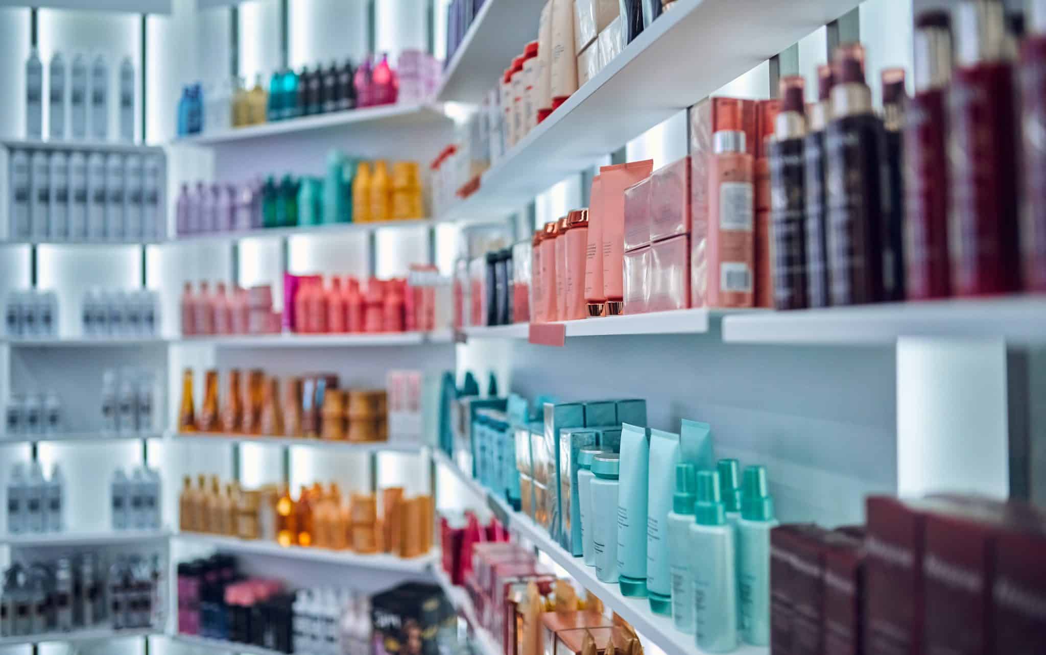 Modern beauty salon interior. Different cosmetics on shelves.