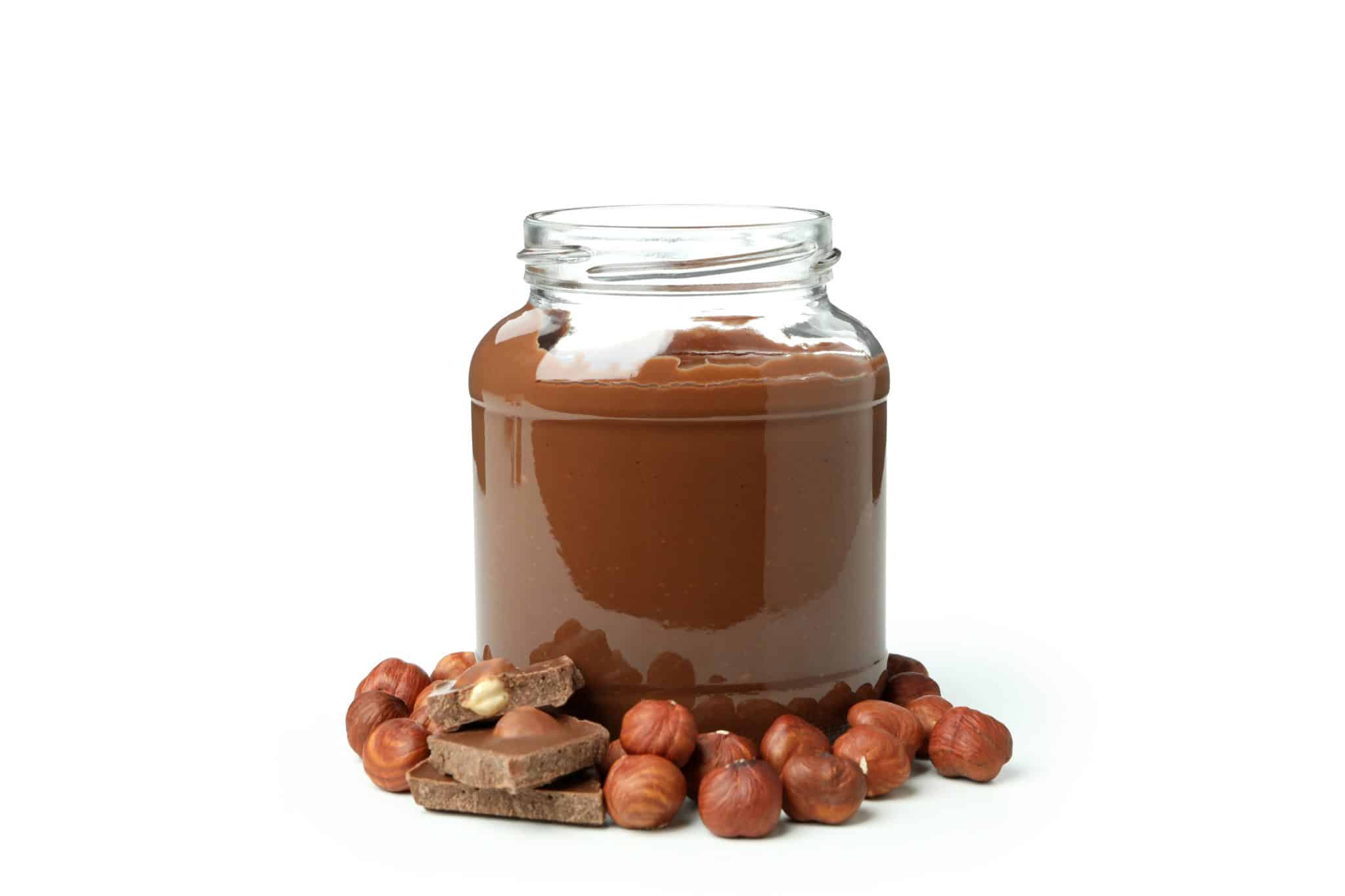 Jar with chocolate paste and nuts isolated on white background